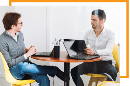 Two consultants discussing a cloud computing performance report
