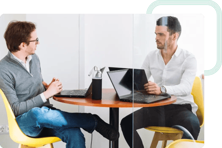 Two consultants discussing a cloud computing performance report